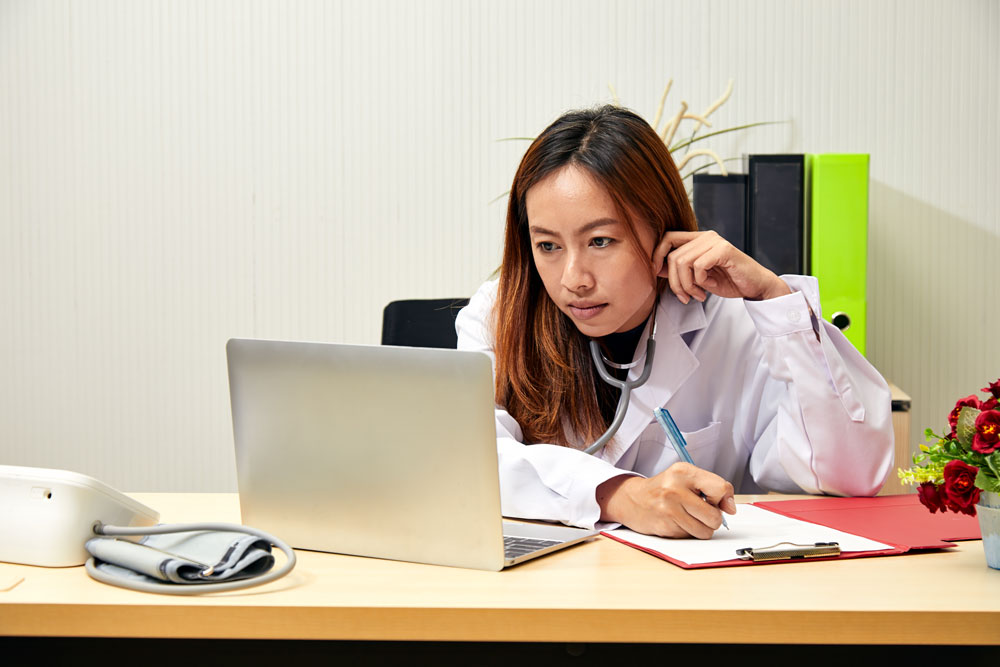 healthcare-provider-using-laptop-and-reviewing-patient-information