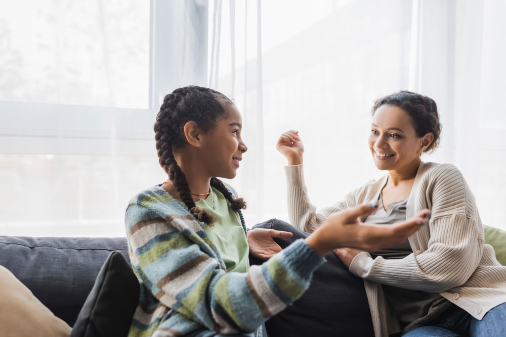 Parent-and-child-engaged-in-conversation-about-health-and-well-being-in-a-home-setting