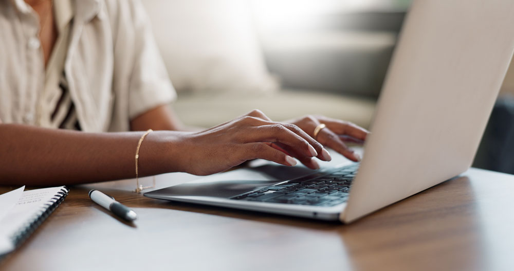 Person-using-a-laptop-to-review-Neuro-QoL-assessment-scores-and-T-score-results-for-patient-reported-outcome-measures