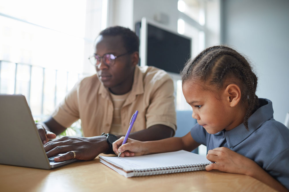 Child-completing-a-learning-activity-with-an-adult-representing-pediatric-assessment-and-developmental-functioning