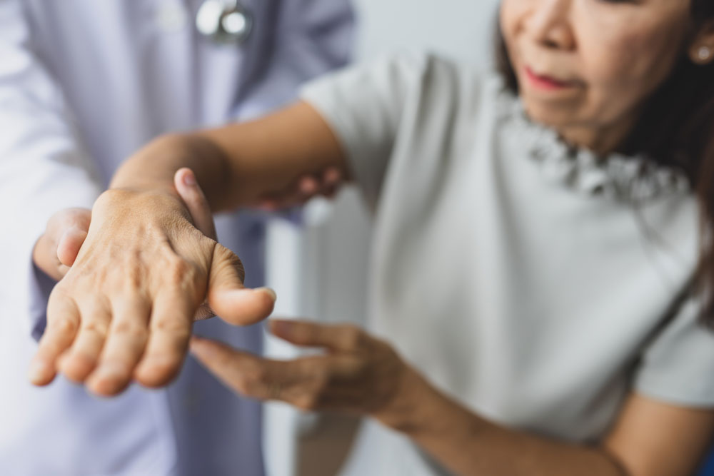 Healthcare-professional-assessing-hand-and-upper-extremity-physical-function-in-an-adult-patient-representing-FDA-qualified-PROMIS-short-forms used-to-measure-fatigue-in-rheumatoid-arthritis-and-physical-function-in-advanced-cancer