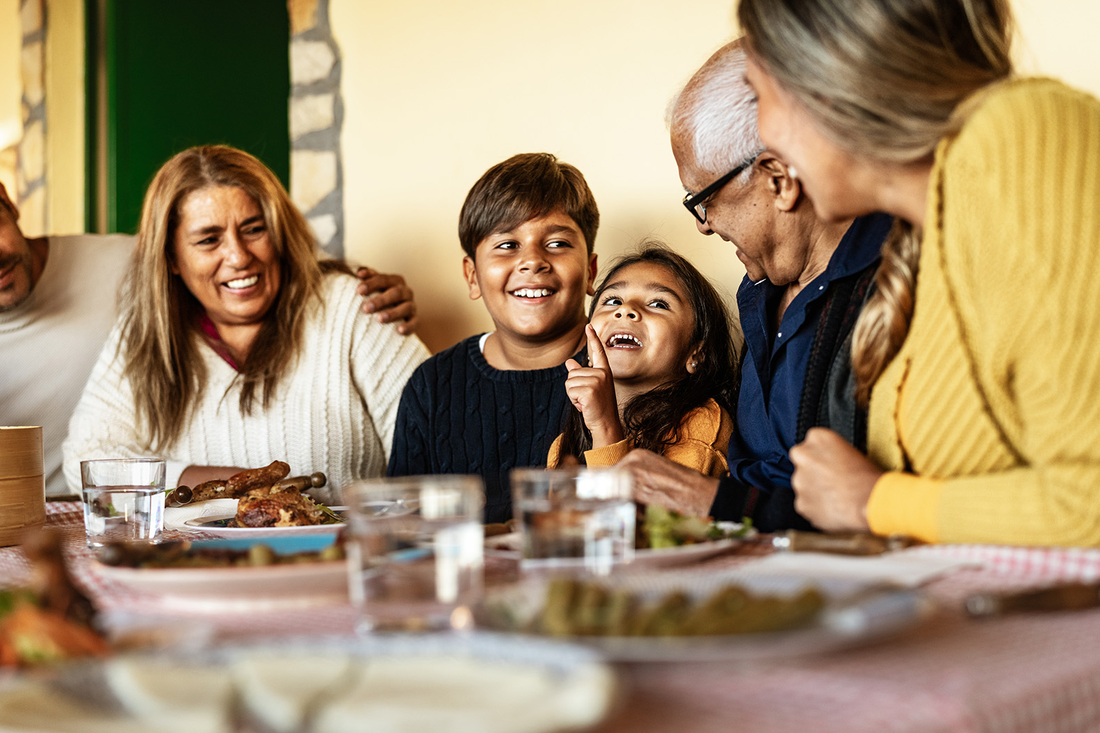 Multigenerational-family-gathered-around-table-representing-diverse-populations-served-by-NIH-Toolbox-Emotion-measures